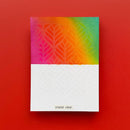 Notebook with colorful embossed design on a red background