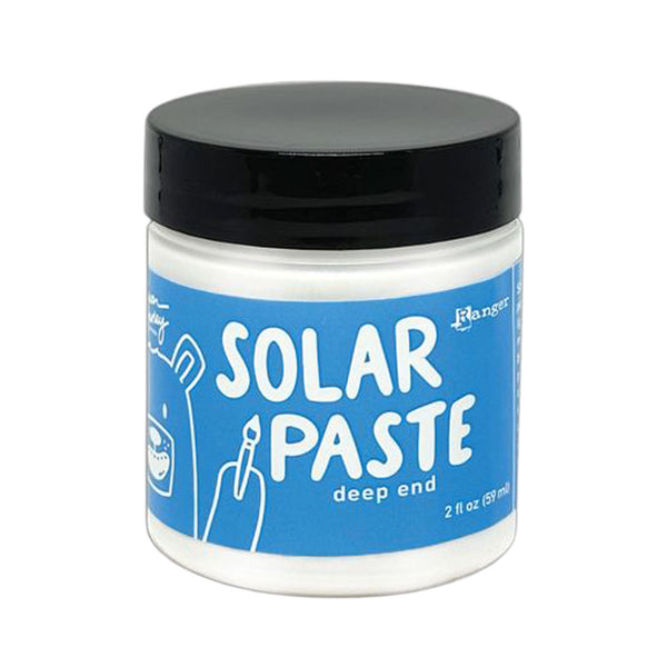 Jar of solar paste with blue label and black lid on white background