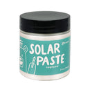 Jar of solar paste with a black lid on a white background
