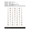 Packaging of 'Simple and Basic' enamel dots with a white background