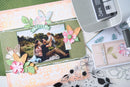 Scrapbooking layout with family photo, decorative elements, and Sizzix machine.