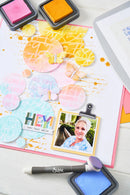 Colorful scrapbooking layout with photo, stamps, and decorative elements on a white background