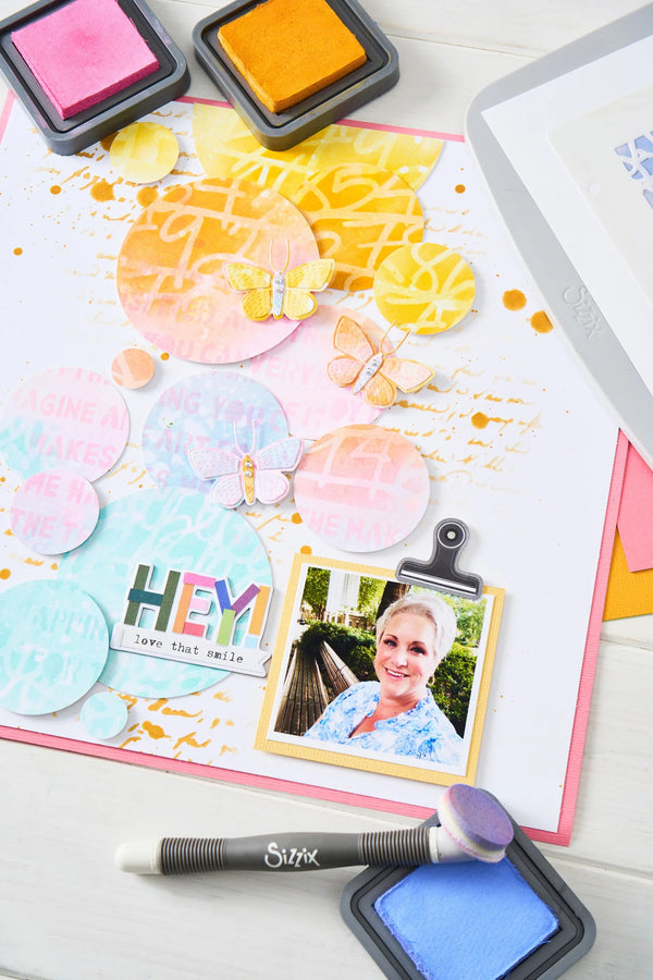 Colorful scrapbooking layout with photo, stamps, and decorative elements on a white background