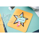 Yellow coaster with star-shaped decorative item and 'WITH LOVE' tag on a teal surface.