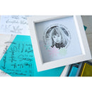 Framed photo of a child with decorative text and snowflake designs on a white background