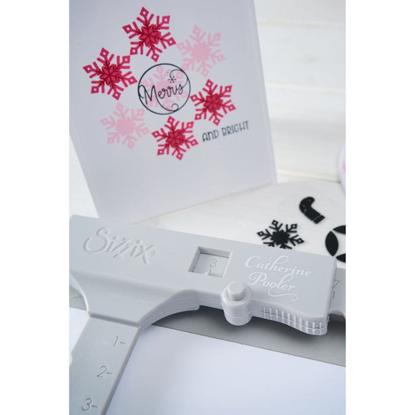 Cricut cutting machine with snowflake designs on a white background