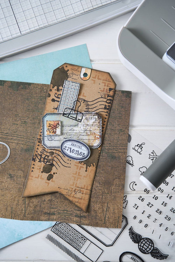 Decorative envelope with vintage design on a desk with crafting tools