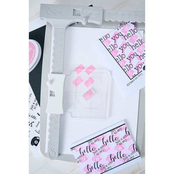 Card making tool with printed cards featuring 'hello' text on a white background