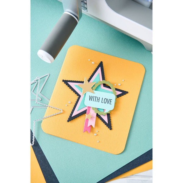 Colorful star-shaped card with 'WITH LOVE' tag on a crafting surface