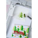 Card with Christmas tree design and 'Merry and Bright' text on a cutting machine.