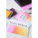 Colorful embossed card with 'You're Invited' text and ink pads on a white background