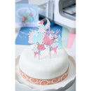 White cake with pink deer cake toppers on a white background