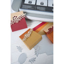 Decorative paper cutouts with floral designs on a printer bed.