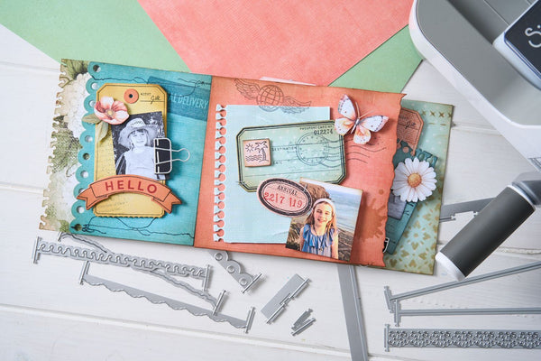 Decorative scrapbooking pages with embellishments on a white surface