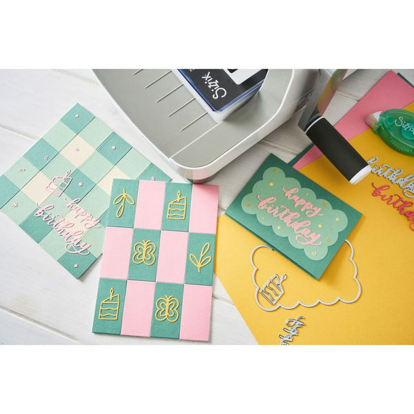 Colorful greeting cards with 'Happy Birthday' text and checkered patterns on a white surface.