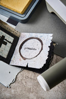 Card with 'possible' printed on it on a textured surface