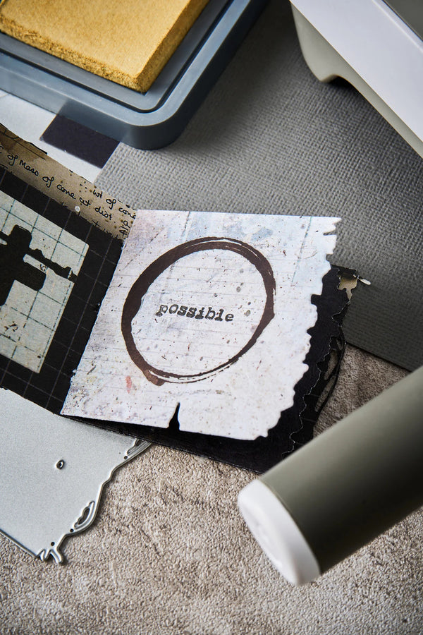 Card with 'possible' printed on it on a textured surface