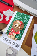 Card with a lion illustration and text 'Jungle All The Way' on a crafting surface.