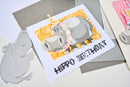 Birthday card with hippo design on a gray surface