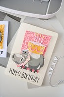 Card with hippo design and 'Hippo Birthday' text on a gray surface
