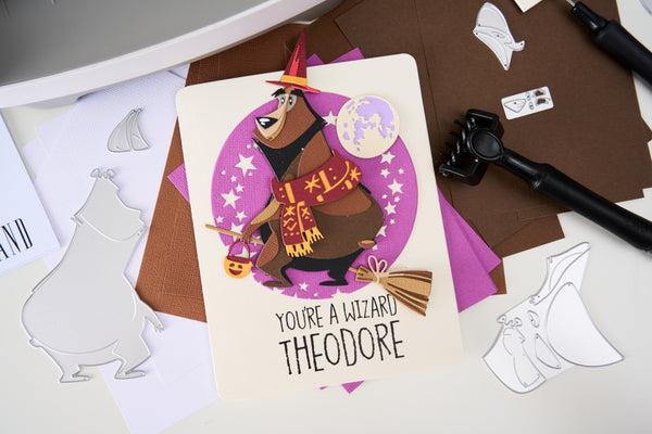 Personalized greeting card with wizard design and text on a craft table.