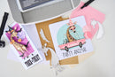 Two greeting cards with animal-themed designs on a white surface.