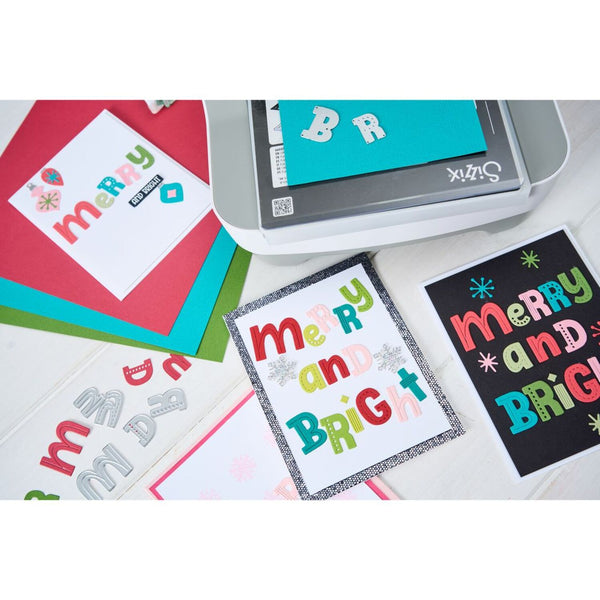 Card-making activity with colorful text on cards and a cutting machine.