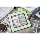 Colorful card design on a green card with crafting tools around