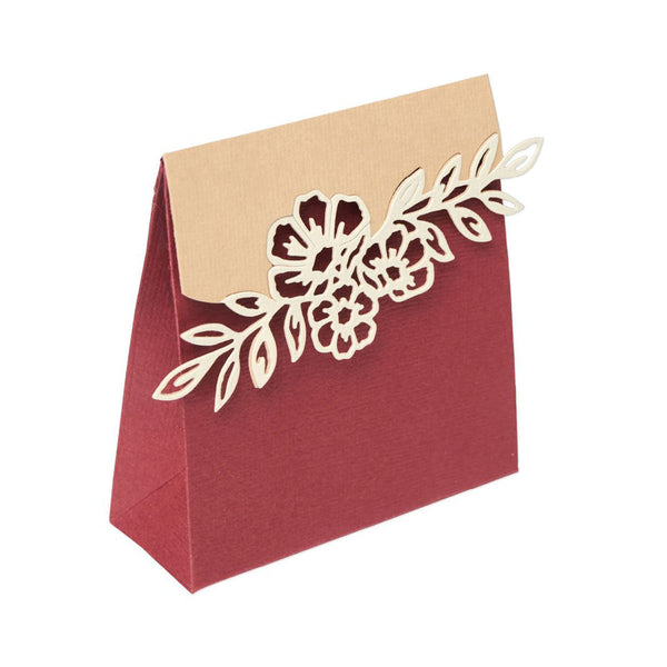 Red paper bag with beige top and floral cutout on a white background