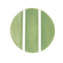 Round green plate with white stripes on a white background