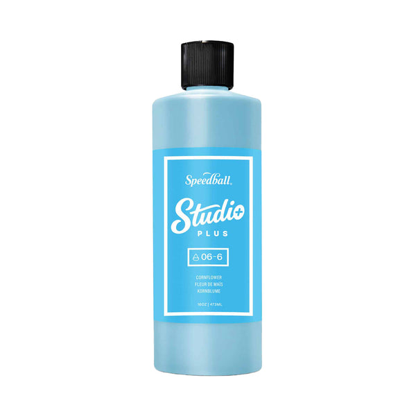 Blue bottle with black cap labeled 'Speedball Studio Plus' on a white background