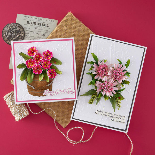 Two floral-themed greeting cards on a textured surface with a red background