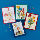 Four colorful greeting cards with house and flower designs on a blue background.