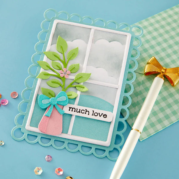 Handmade card with floral design and 'much love' text on a blue background