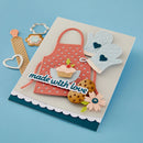 Card with a red apron, cupcake, cookies, and text 'made with love' on a blue background