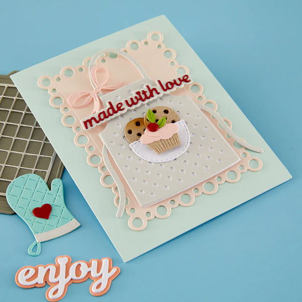 Decorative card with 'made with love' text and cupcake illustration, accompanied by a small oven mitt on a blue background.