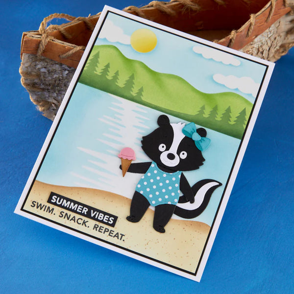 Card with a cartoon badger holding an ice cream, set against a scenic background with mountains and trees.