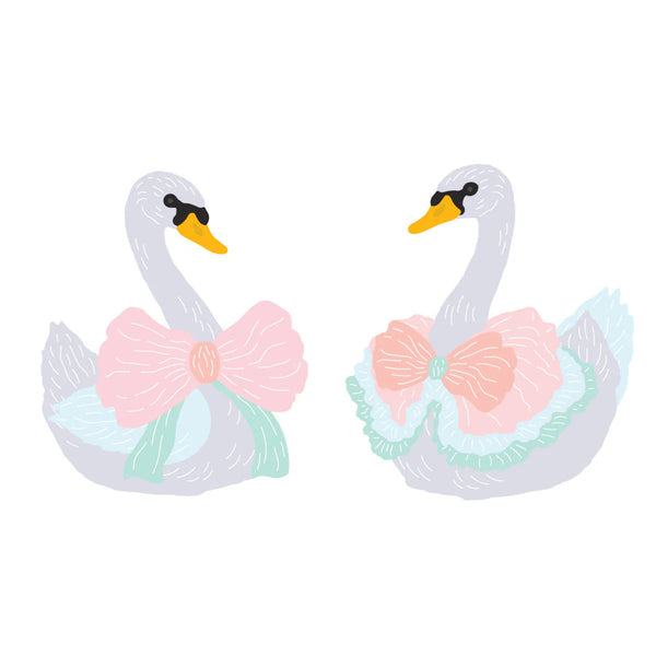 Two inflatable swan floats with pink bows on a white background