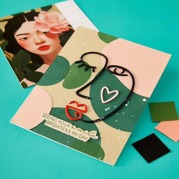 Jewelry set on a decorative card with a teal background