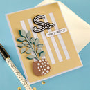 Handmade card with decorative elements on a blue background