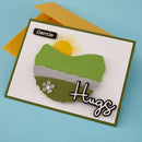Card with green landscape design, sun, and flower on a blue background