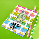 Colorful napkin with a crocodile design and 'wish big' text on a green background