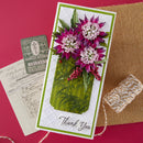 Greeting card with floral design and 'Thank You' text on a textured surface.