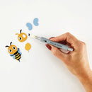 Hand holding a pen with cartoon bee and butterfly illustrations on a white background