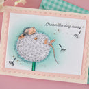 Card with a mouse sitting on a dandelion puff and the text 'Dream the day away' on a pink background.