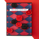 Checkered card with red and black bottle caps on a red background