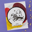 Sticker with Leo zodiac sign on a purple background