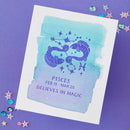 Pisces zodiac card with watercolor design on a purple background
