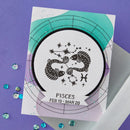 Card with Pisces zodiac sign design on a purple background