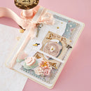 Decorative card with flowers, ribbons, and decorative elements on a pink background